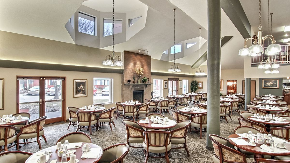 A spacious dining area with elegantly set tables and large windows.