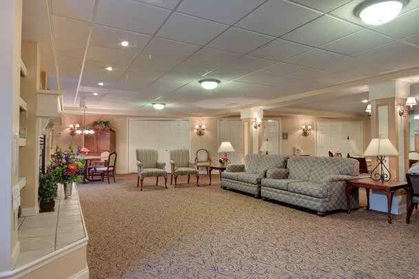 A spacious living room with comfortable seating and warm lighting.