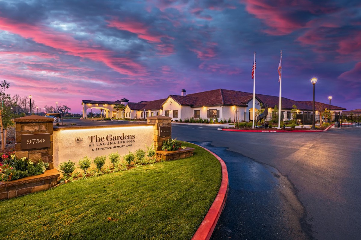 A scenic view of a retirement community building at sunset with vibrant skies.