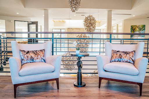 A stylish and modern living room setup featuring elegant chairs and unique lighting.