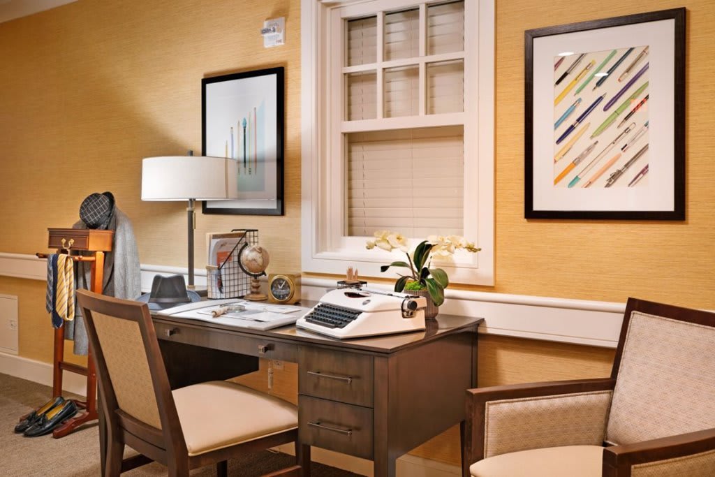 A cozy home office with a wooden desk and modern decor.