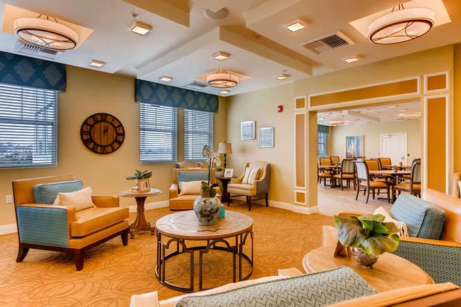 A cozy living room with comfortable seating, decorative elements, and large windows letting in natural light.