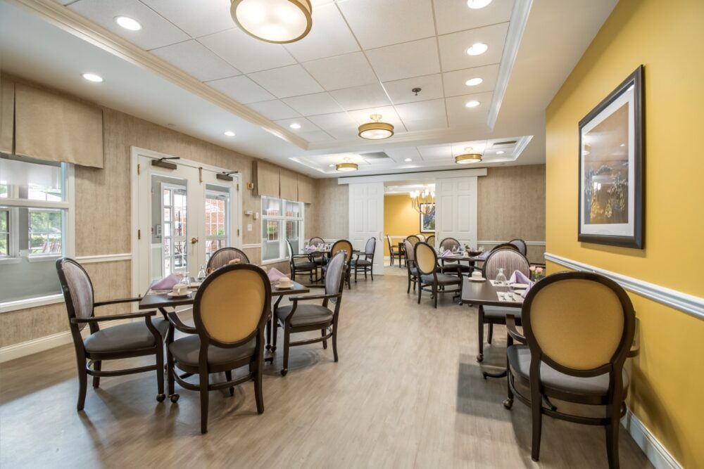 An elegant and spacious restaurant dining area with neatly arranged tables and chairs.