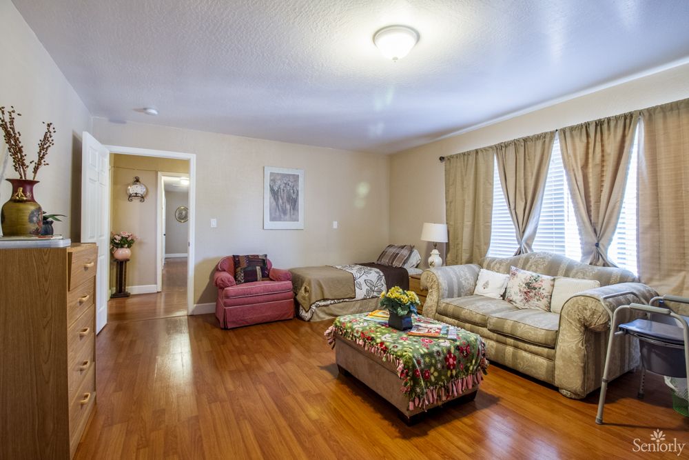 A cozy living room with a sofa, armchair, and a decorated coffee table.