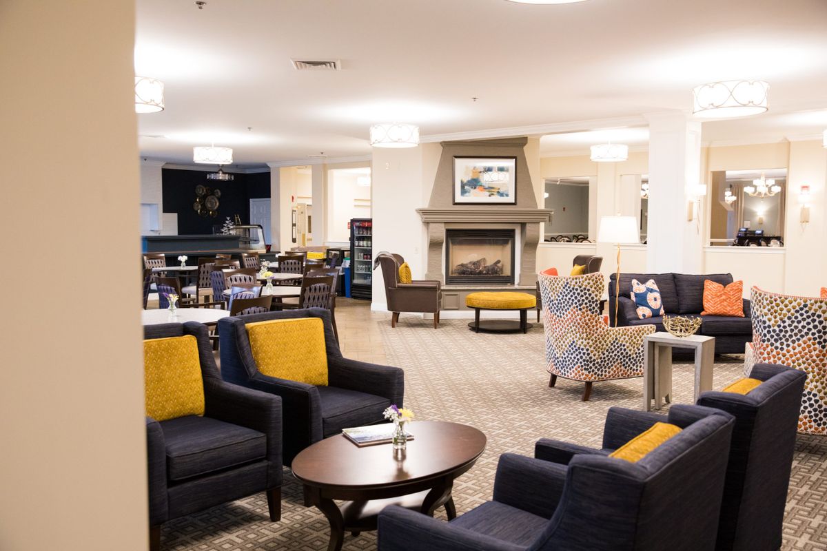 A spacious and modern living room with comfortable seating and a fireplace.