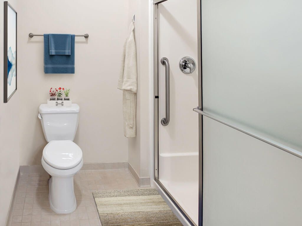 A modern bathroom with a toilet and shower.