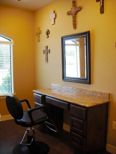 A cozy vanity area featuring a mirror and decorative crosses on the wall.