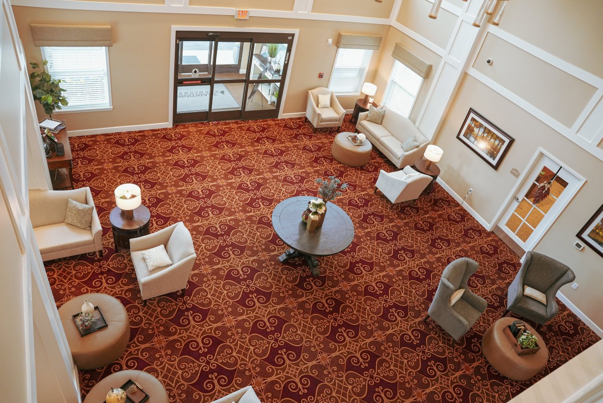 A spacious lobby with comfortable seating and decorative carpet.