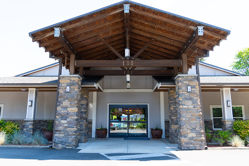 The inviting entrance of a beautifully designed building featuring wood and stone architecture.