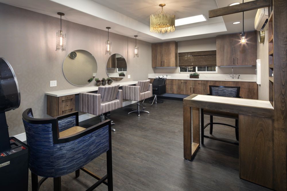 A modern salon interior with stylish furniture and elegant lighting.