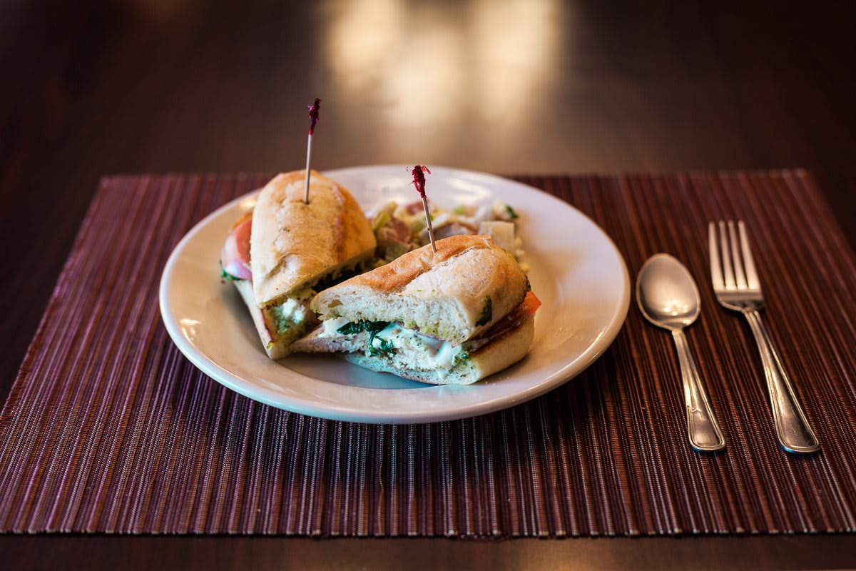A delicious sandwich served on a white plate, ready to enjoy.