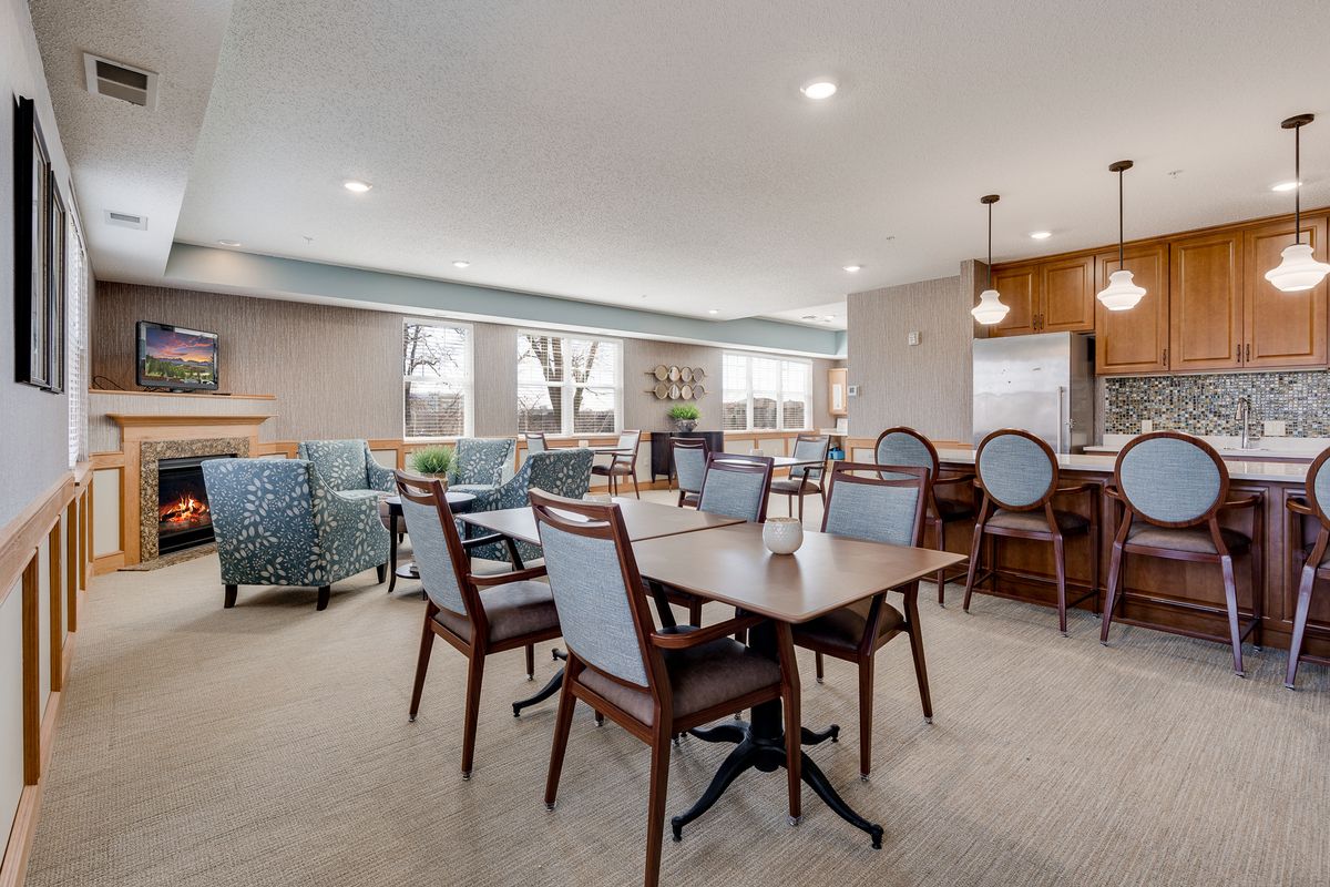 A modern dining area with elegant furnishings and ample seating.