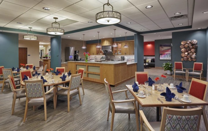 A cozy restaurant dining area with neatly arranged tables and ambient lighting.