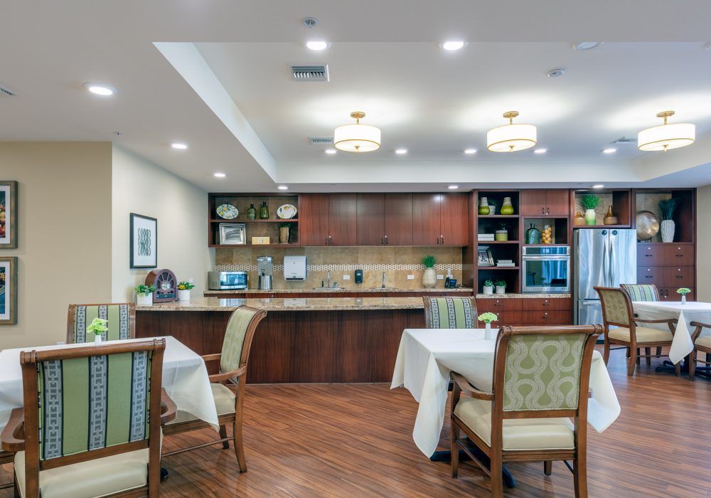 A modern kitchen and dining area with wooden cabinetry and elegant furniture.