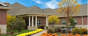 A beautiful house with a well-maintained garden and vibrant flowers.