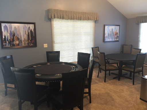 A stylish dining area featuring a poker table and artwork on the walls.