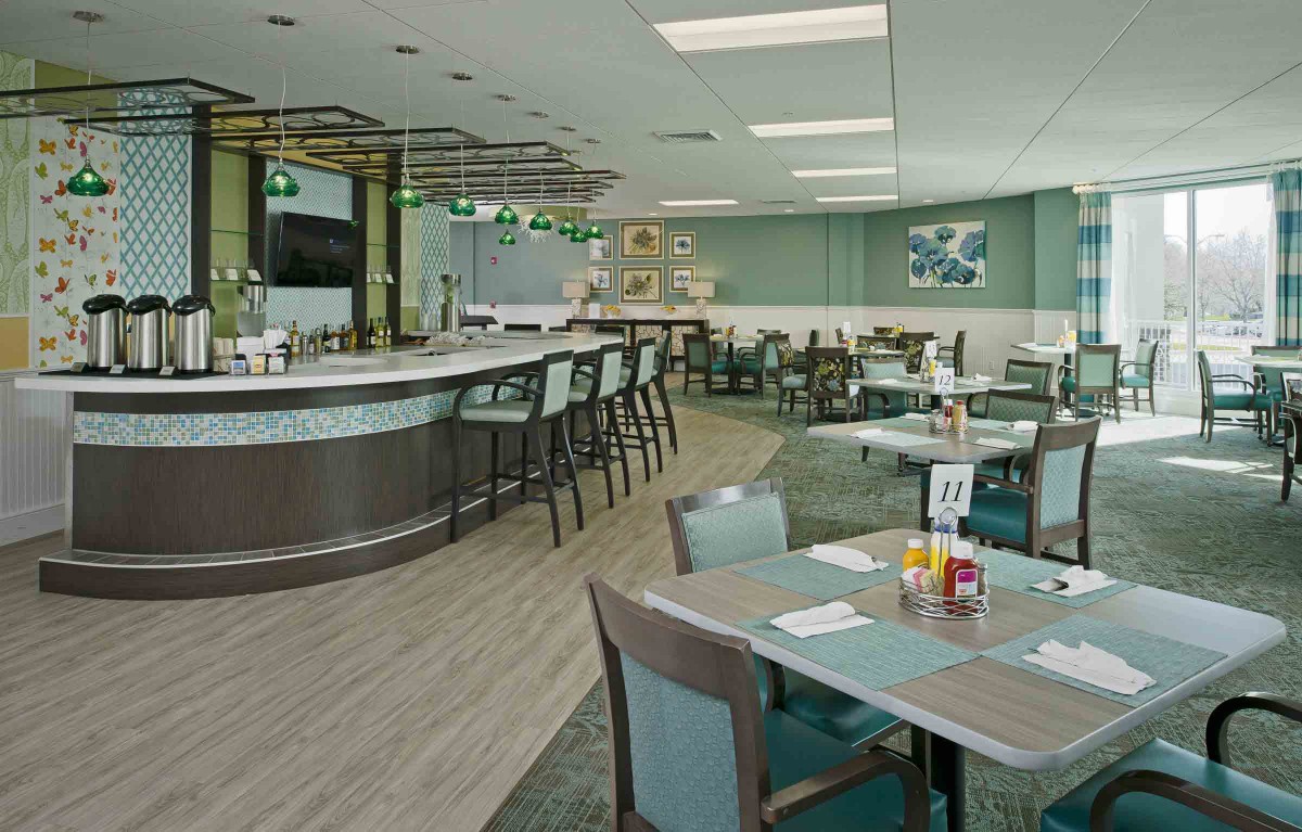 Modern restaurant interior with bar and seating area.