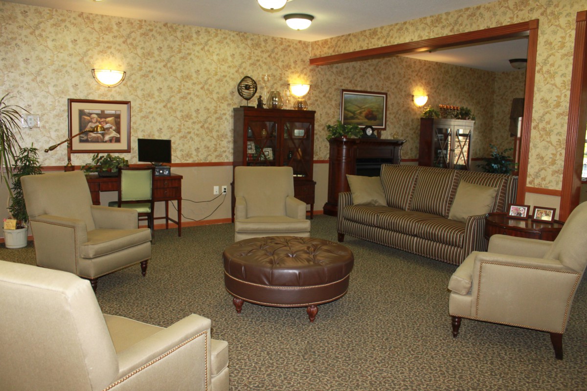 A cozy living room with sofas, armchairs, and a coffee table arranged for comfort and conversation.