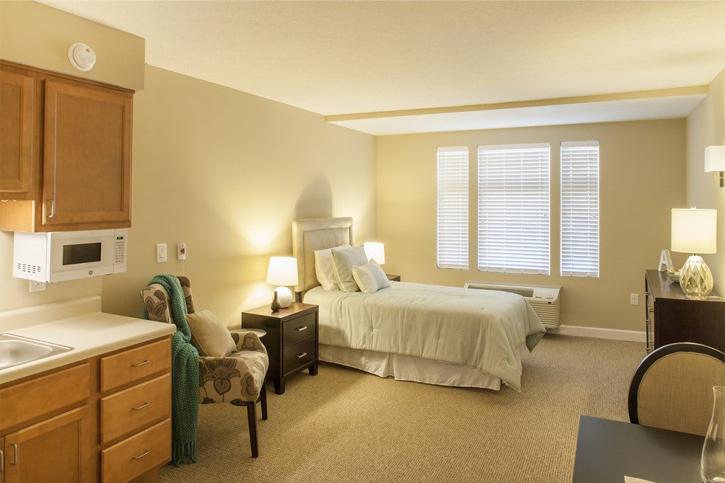 A cozy bedroom with natural lighting and elegant furnishings.