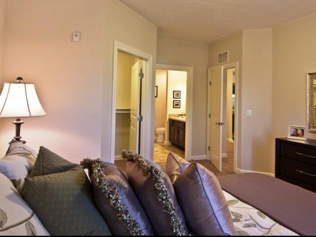 A cozy bedroom with stylish decor and soft pillows on the bed.