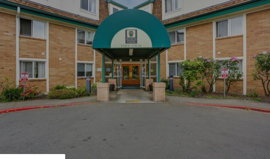 The entrance of a hotel with a green awning.