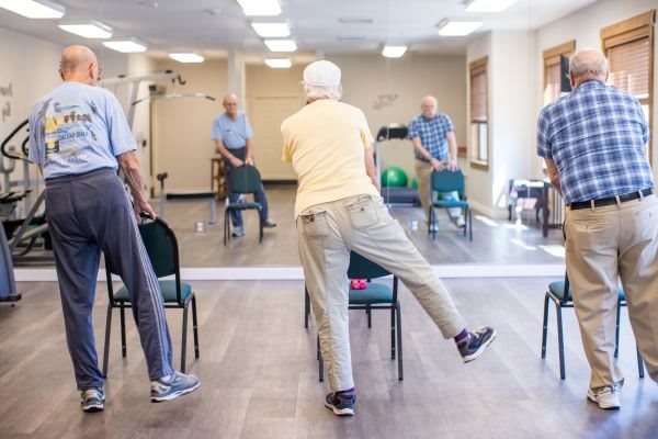 A group of seniors participating in a fitness class focusing on balance exercises.