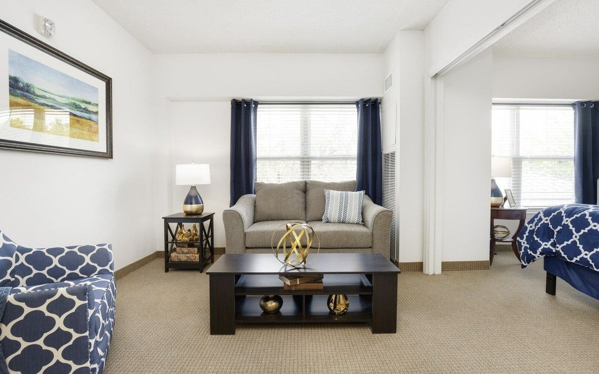 A cozy living room with a sofa, coffee table, and stylish decor.