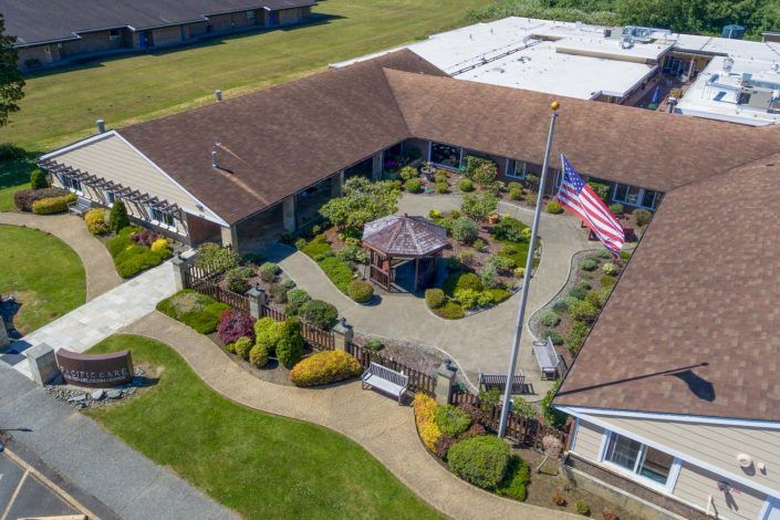 Aerial view of a building with a garden courtyard and flagpole.