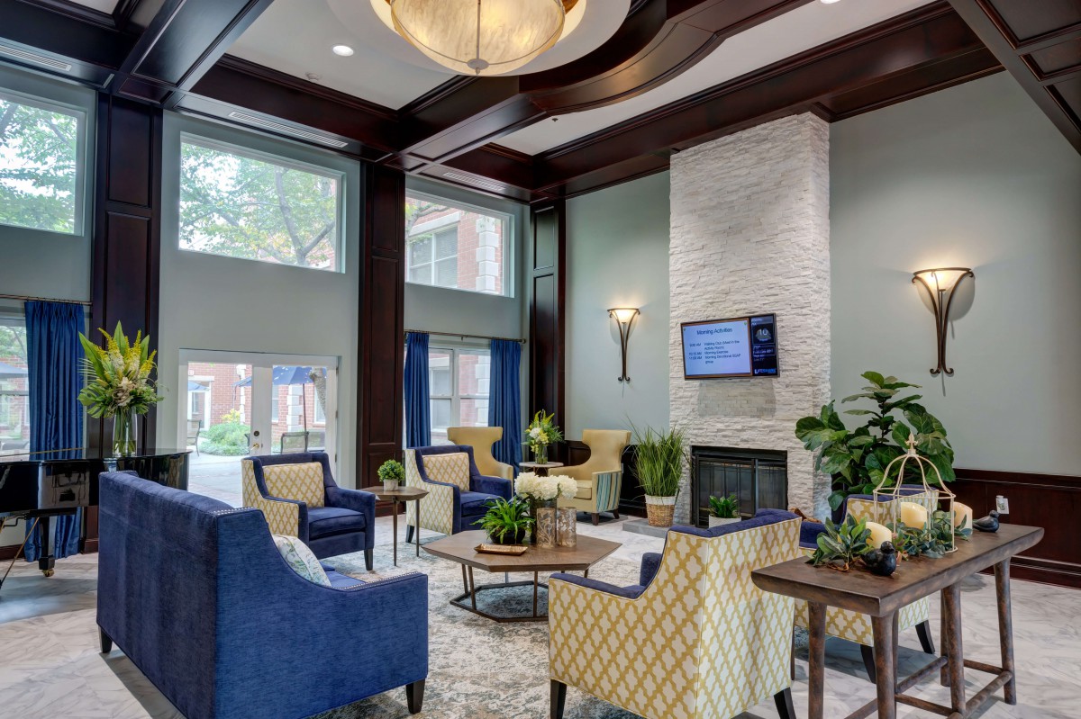 A modern and elegant living room with a cozy seating area and fireplace.
