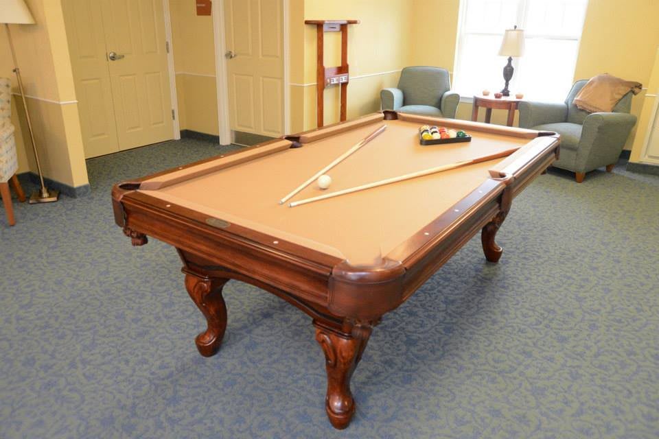 A billiards table set up in a recreational room.
