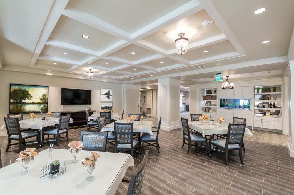 A spacious and elegantly designed dining area with modern furniture and lighting.