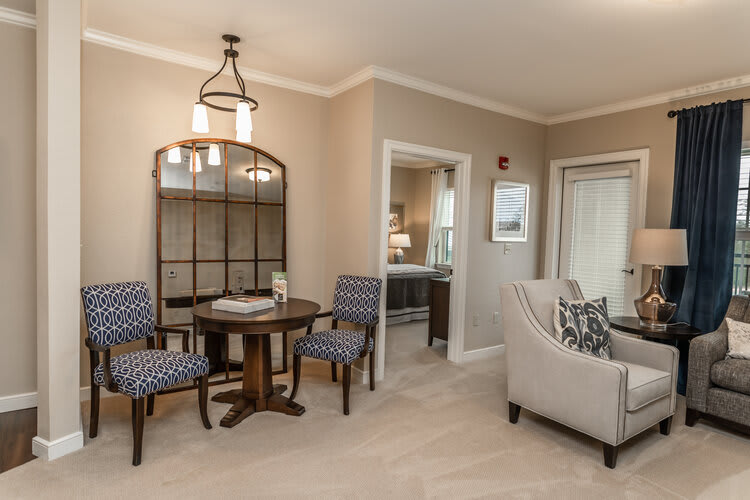 A cozy living and dining area with elegant furniture and neutral tones.
