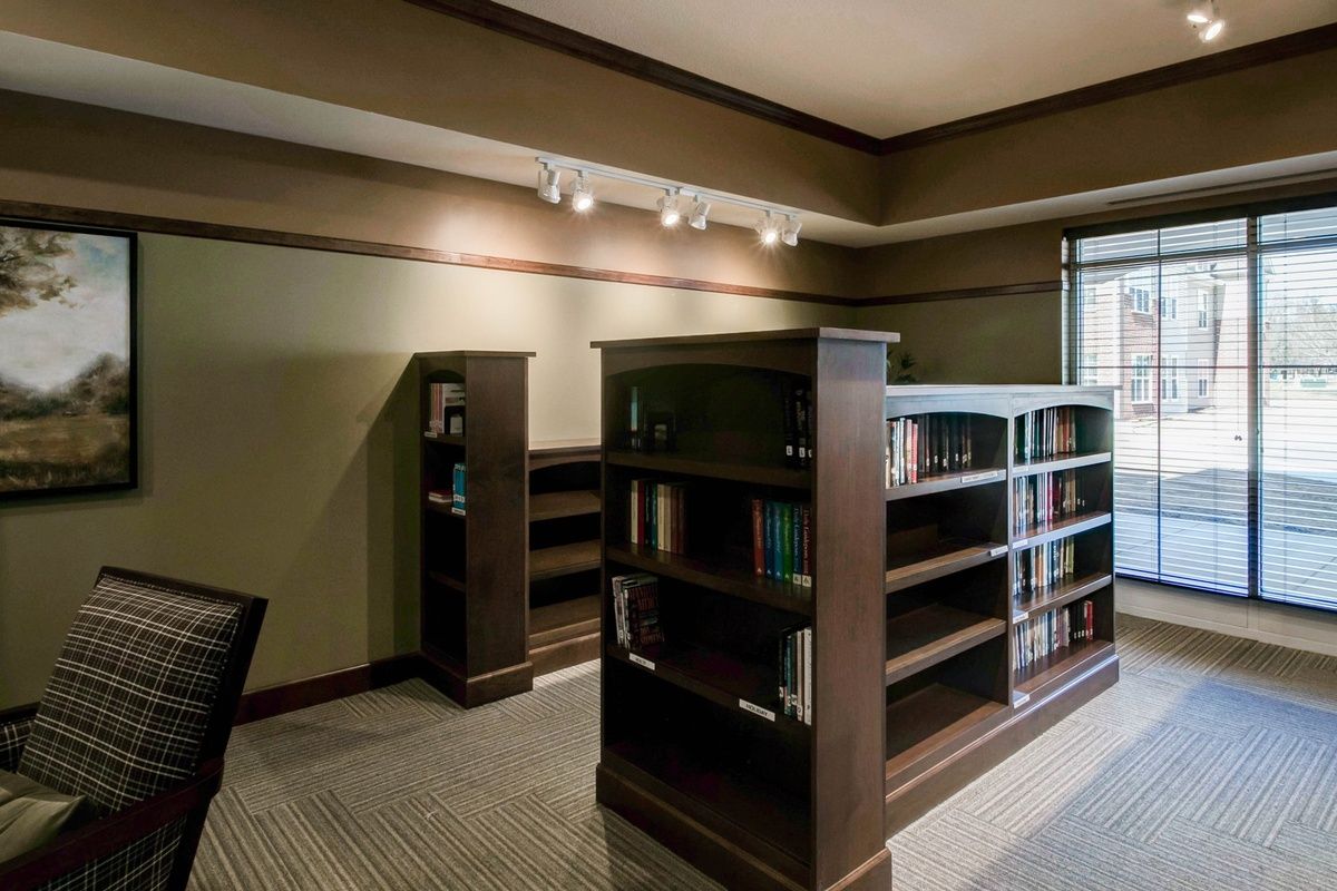 A quiet library interior with wooden bookshelves and a cozy reading area.