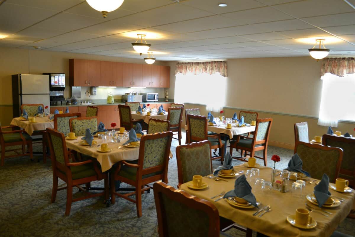 A formal dining area with neatly arranged tables and chairs.