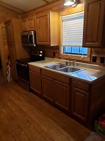 A cozy kitchen with wooden cabinets and stainless steel appliances.