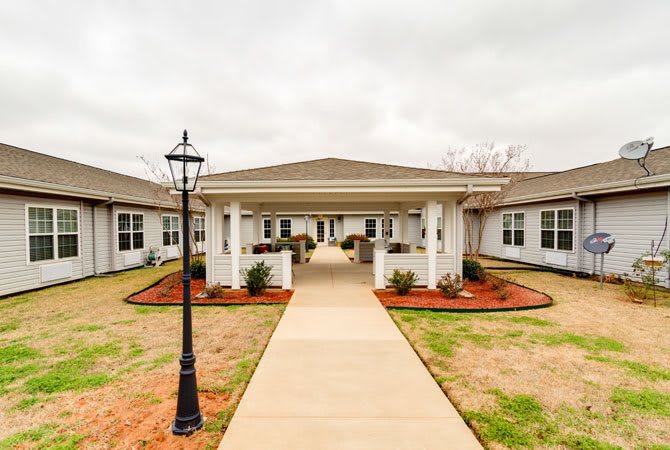 A well-maintained building with a central pathway and landscaped surroundings.
