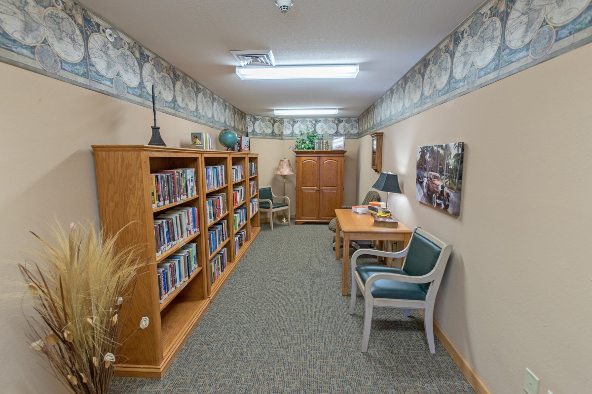 A cozy library corner with bookshelves and seating.