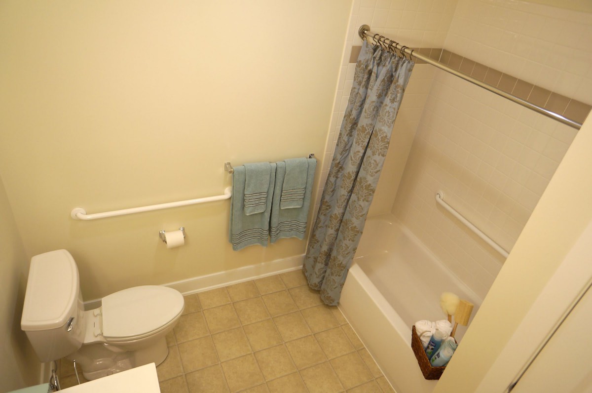 A clean bathroom with a shower and toiletries.