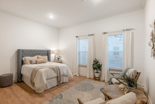 A cozy and modern bedroom featuring a comfortable bed, stylish furnishings, and ample natural light.