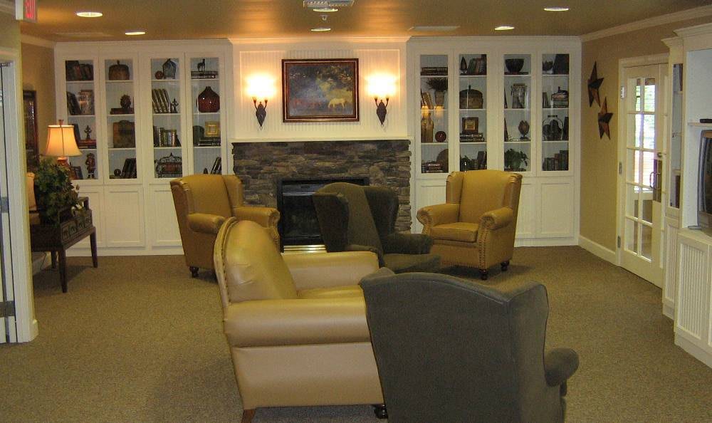 A cozy lounge area featuring comfortable chairs and a fireplace.