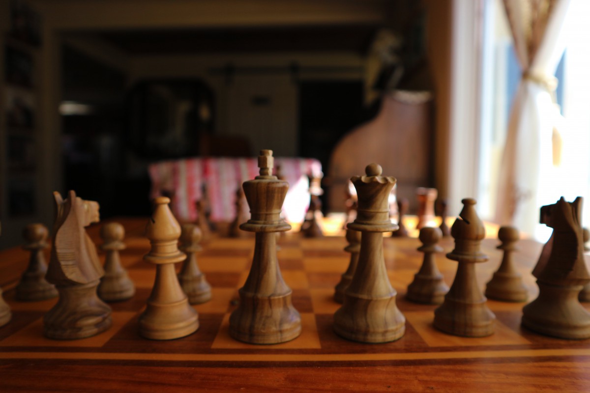 A close-up view of a chessboard with pieces set up, ready for play.