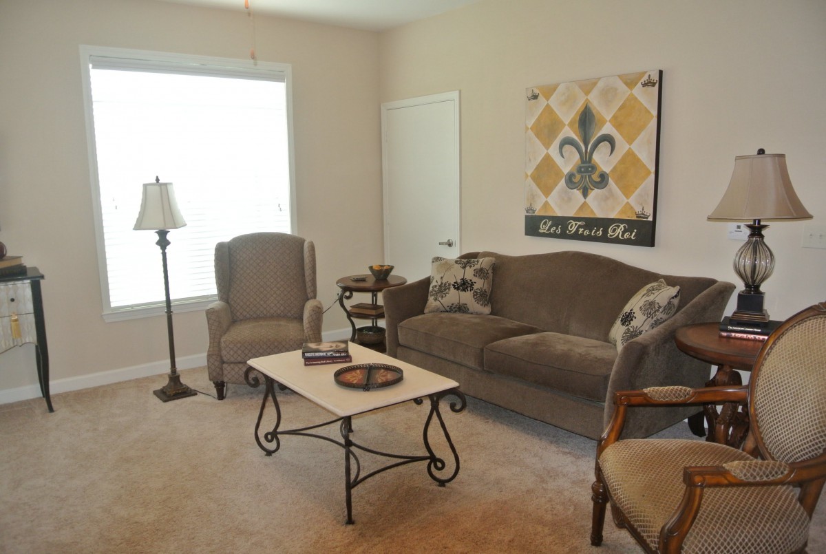A cozy living room with a sofa, armchairs, and a decorative coffee table.