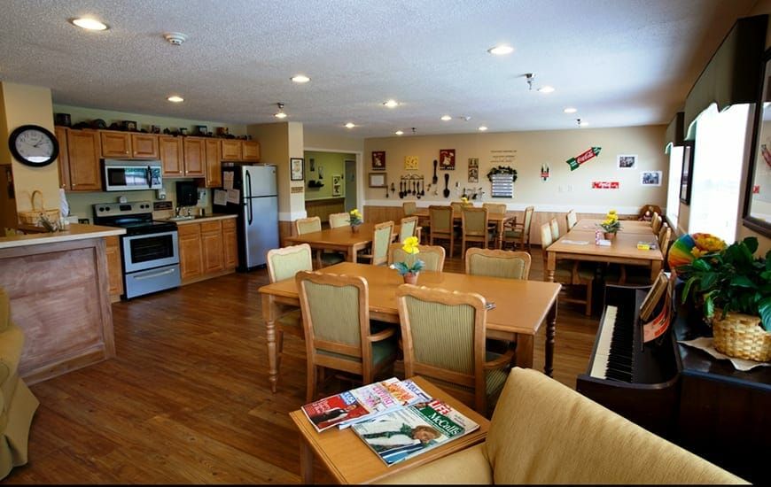 A spacious community kitchen and dining area with modern appliances and cozy furnishings.