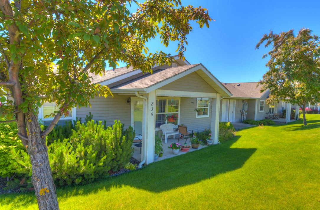 A cozy house with a well-maintained front yard on a sunny day.