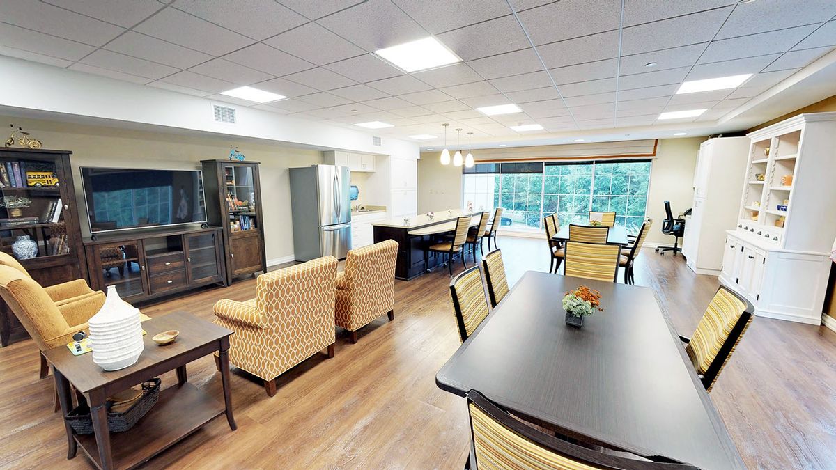 A spacious and well-lit living area with comfortable seating and large windows.