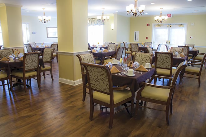 A cozy dining room with elegant furniture and warm lighting.