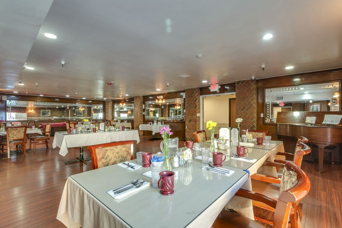 An elegantly decorated restaurant dining area with neatly arranged tables and chairs.