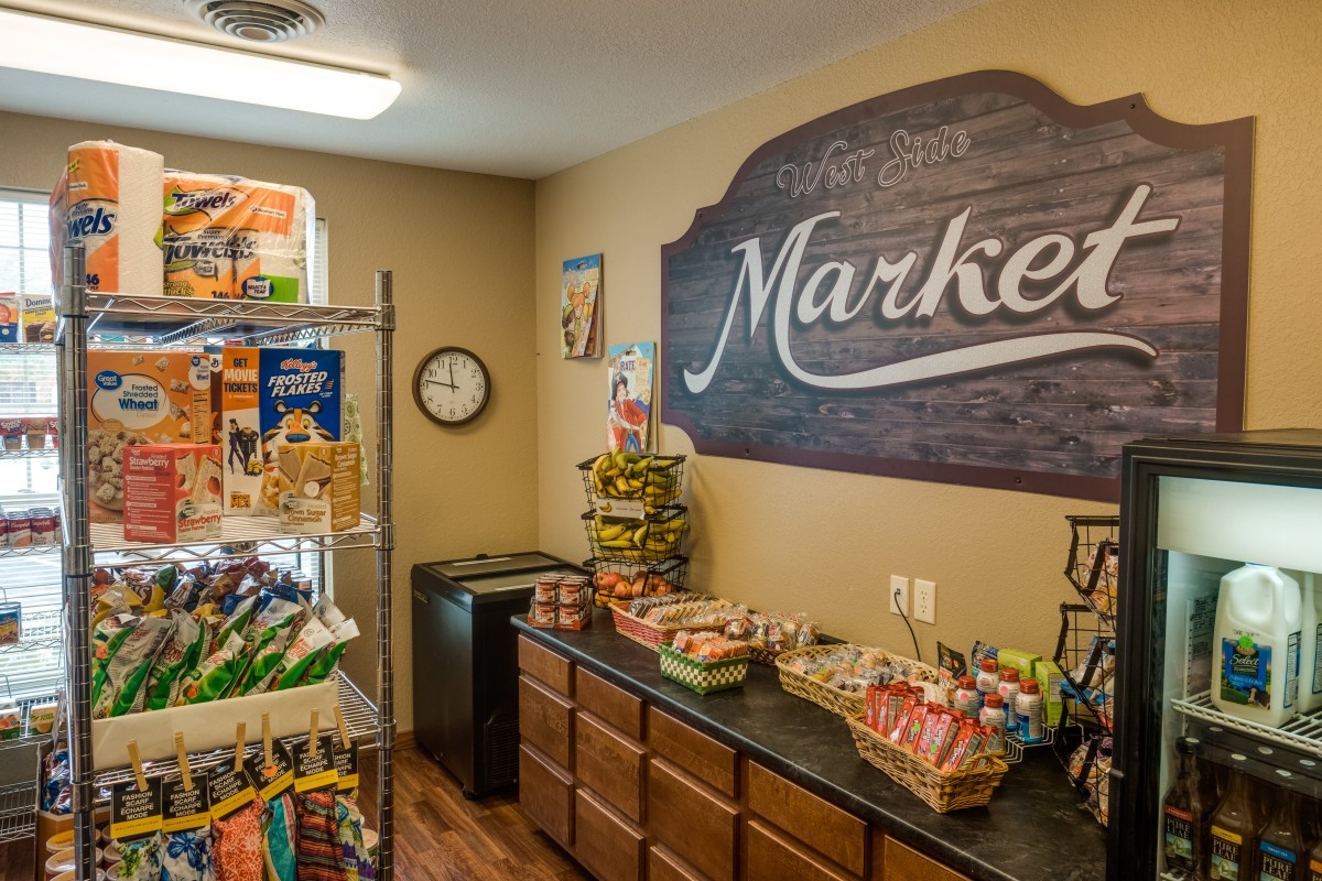 A cozy indoor market with shelves stocked with snacks and food items.