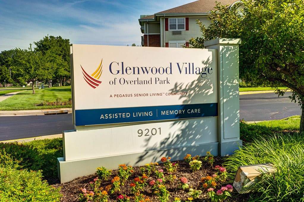 Entrance sign for Glenwood Village of Overland Park, offering assisted living and memory care services.