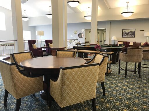 A spacious dining area with elegant furniture and soft lighting.